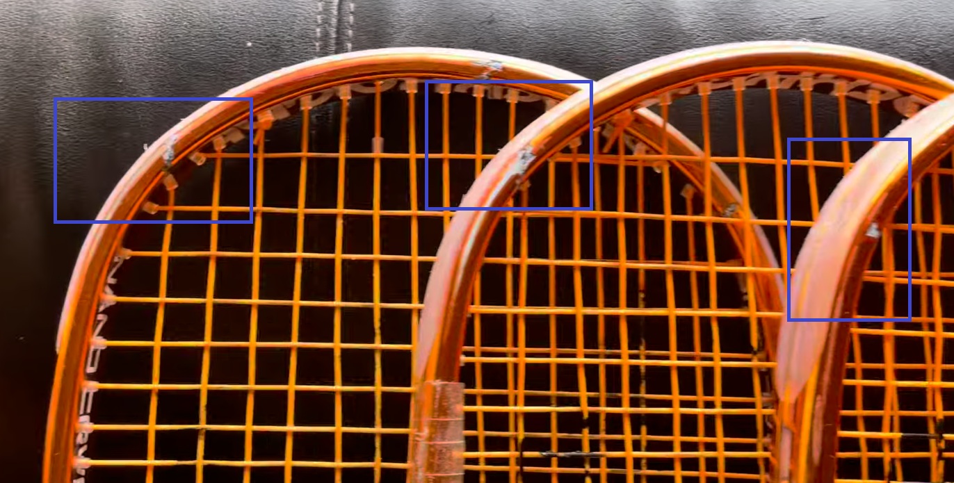 Multiple Black Knight Ion Storm rackets with cracks highlighted showing systematic manufacturing defect