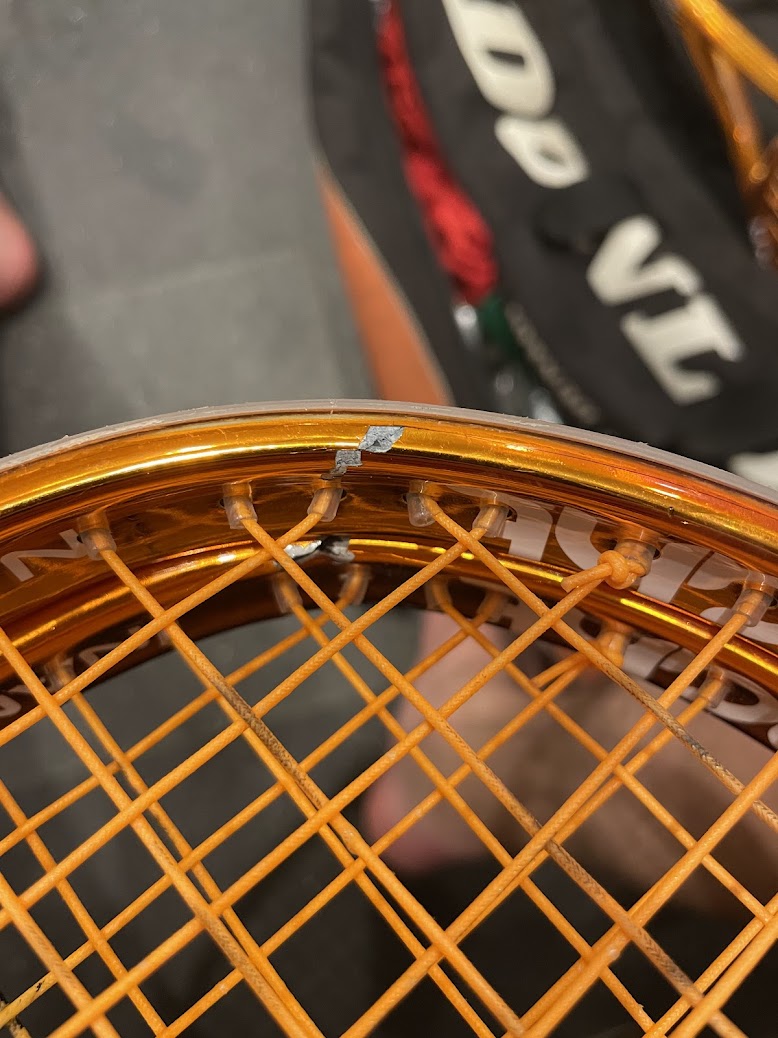 All Black Knight Ion Storm rackets from batch lined up showing every single one cracked at the frame head